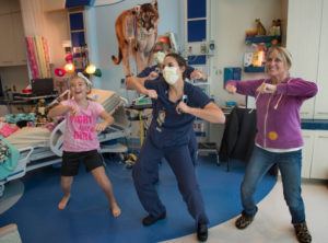 Lilly Vanden Bosch gets moving with nurses Jamie Albert, Christina Barton, and Lilly's mom Meg. 