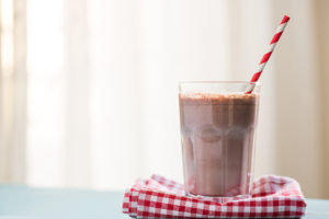 A chocolate milkshake with a straw