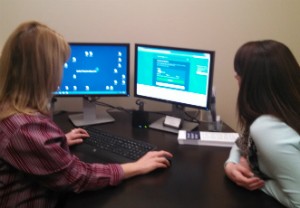 Spectrum Health financial resource advisors/certified application counselors Rhonda Hedlund, left, and Kate Spaulding peruse the healthcare.gov page at Fremont's Gerber Memorial Hospital.