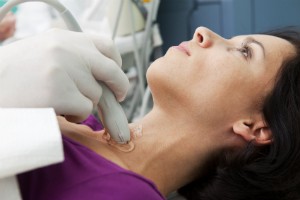 A woman gets her thyroid looked at.