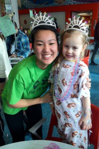 A Hope College student poses for a photo with a young patient at Spectrum Health Helen DeVos Children's Hospital.