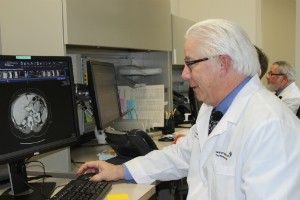 Dr. Julian Schink examines a tumor at Spectrum Health Medical Group's Gynecologic Oncology department in the Lemmen-Holton Cancer Pavilion.
