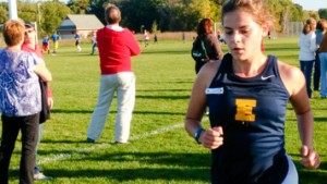 Gabrielle Alter runs outside for a cross country race.