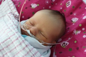 Norah Boss is shown asleep, attached to a breathing tube at Spectrum Health Helen DeVos Children’s Hospital.