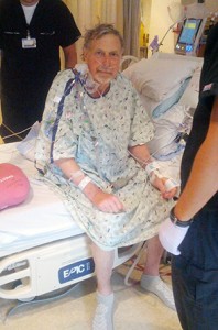 Gordon Veldman is shown sitting on a hospital bed.
