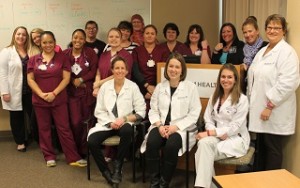 A group of Spectrum Health professionals pose for a photo.