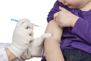 A little girl gets a vaccine.