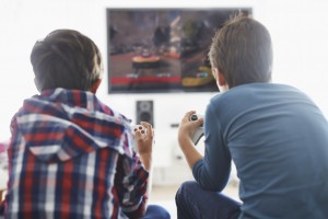 Two boys play video games together.