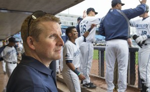 Dr. Matt Axtman, with Spectrum Health Medical Group Orthopaedics and Sports Medicine, sits in the dugout of the West Michigan Whitecaps.