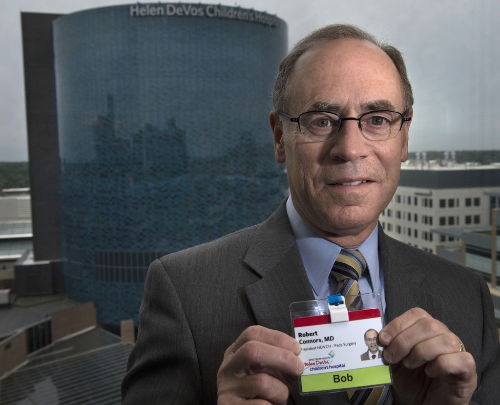 Dr. Robert Connors, president of Spectrum Health Helen DeVos Children's Hospital, poses for a photo with his name badge. His badge says, "Bob."