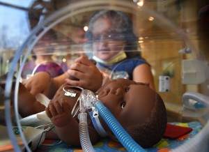 Beannet Reynaga, a third-grader at Parkview Elementary School in Wyoming, changes the diaper of a NICU doll during the annual Doctor’s Day at the Grand Rapids Children’s Museum. Photo taken Friday, May 1, 2015. (Chris Clark | Spectrum Health Beat)
