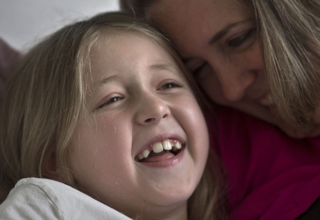 Tammy Ledkins laughs with her daughter Erin, 8, in their room at Spectrum Health Helen DeVos Children's Hospital.