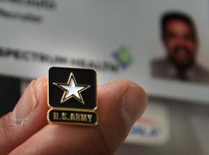 Army veteran David Decouto shows off his "U.S. Army" pin.