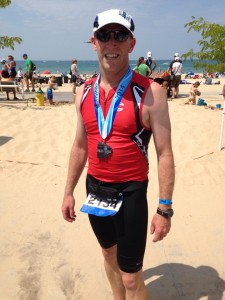 Scott Smith poses for a picture after a triathlon.