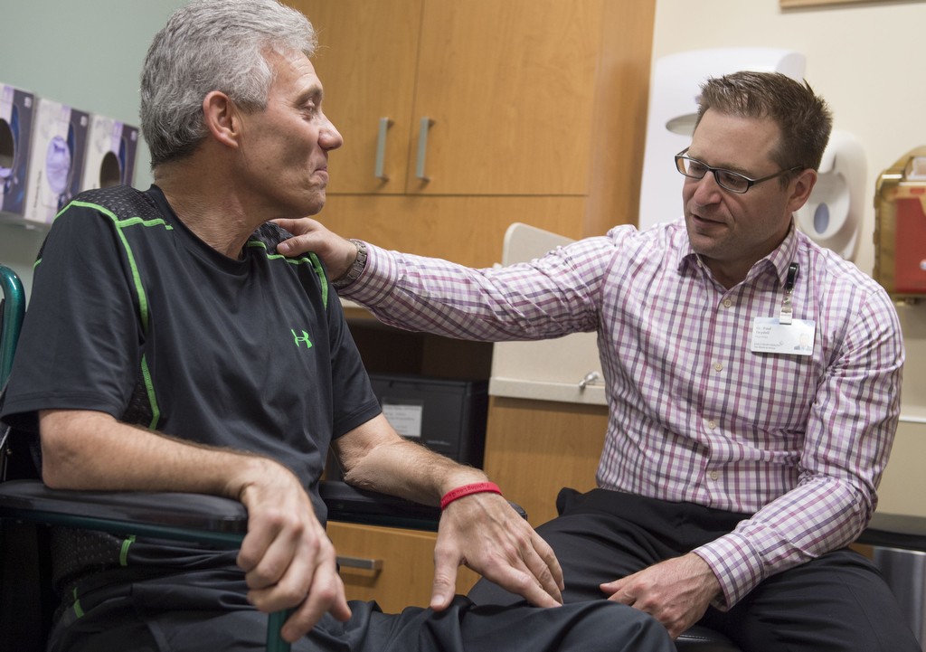 Todd Alward meets with neurologist Paul Twydell, DO, at the Spectrum Health Medical Group Integrated Care Campus at East Beltline.
