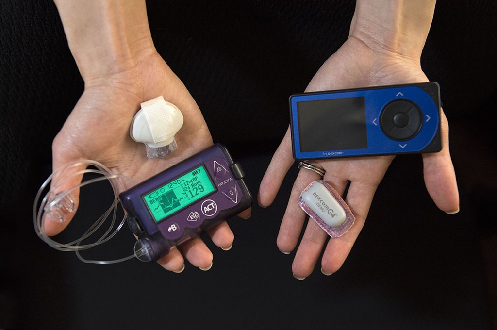 A Spectrum Health diabetes educator shows two glucose monitoring devices that are available for patients. 
