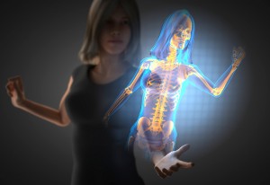 A woman reaches out her hand toward a hologram of her bones.