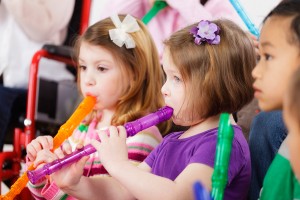 A group of kids play the recorder.