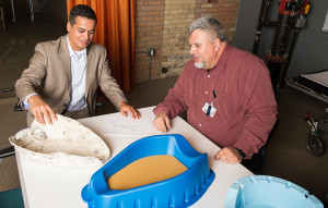 Angel Dominguez demonstrates a newly designed basin that improves patient care to CEO Louis Weijers.