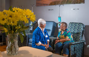 Ludington Hospital volunteer Nancy Lundberg talks with cancer patient Kathleen Howe.