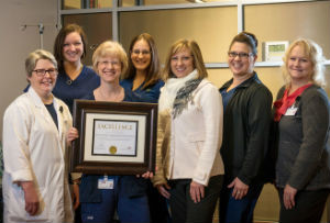 Spectrum Health Ludington Hospital Cancer & Hematology staff with the Award of Excellence from Great Lakes Caring.
