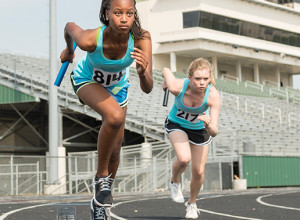 Two woman race during a track and field meet.