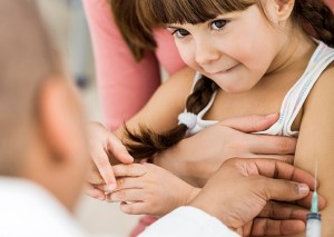 A young girl gets a flu vaccine.