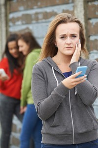 A woman appears distraught as she holds her phone.