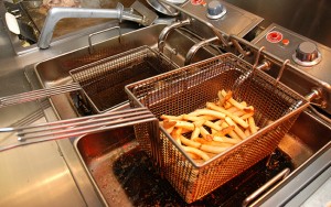 Fries sit in a fryer.