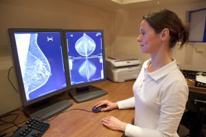 A radiology technician reviews a mammogram image.