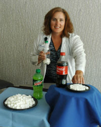 Rebecca Patterson, RD, CDE, shows how much sugar is consumed in one 20-ounce Coca-Cola and how much sugar is consumed by drinking one 20-ounce Mountain Dew.