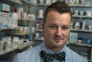 Ryan Foster, director of pharmacy at Spectrum Health, poses for a photo and smiles. Ryan wears a bowtie.