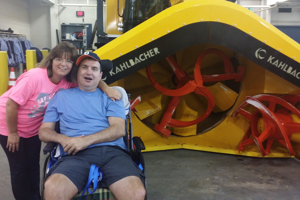Todd Maxim and his therapeutic recreation coordinator, Nina Thomure, poses for a photo and smiles.