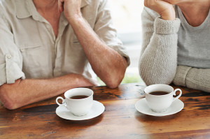 Two adults enjoy a cup of coffee.