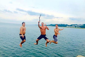 Thomas Stid and friends dive into a lake.