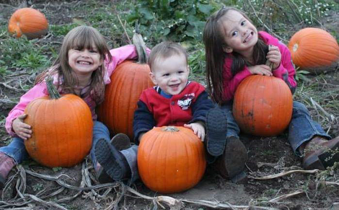 The Geers children Hailey, Jay and Natalie poses for a photo with pumpkins.
