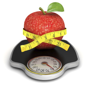 An apple sits on a weight scale.