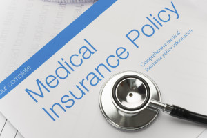 A medical insurance policy packet is shown.