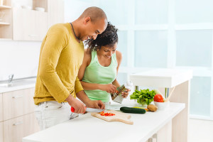 A couple prepares a meal together in their kitchen.