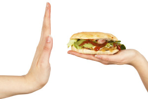 A person pushes away a fast food sandwich.
