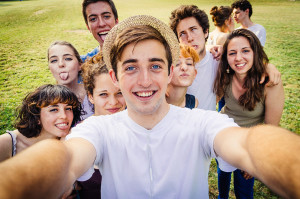 A group of teenagers take a selfie together.