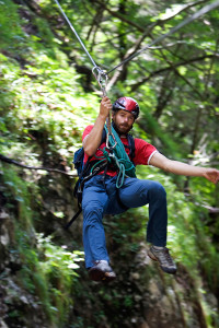 A man is shown zip lining.