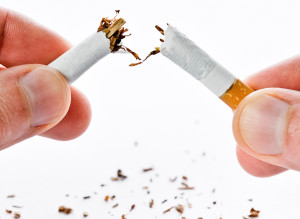 A person breaks a cigarette into two.