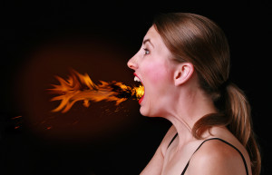 A woman breathes out fire. 