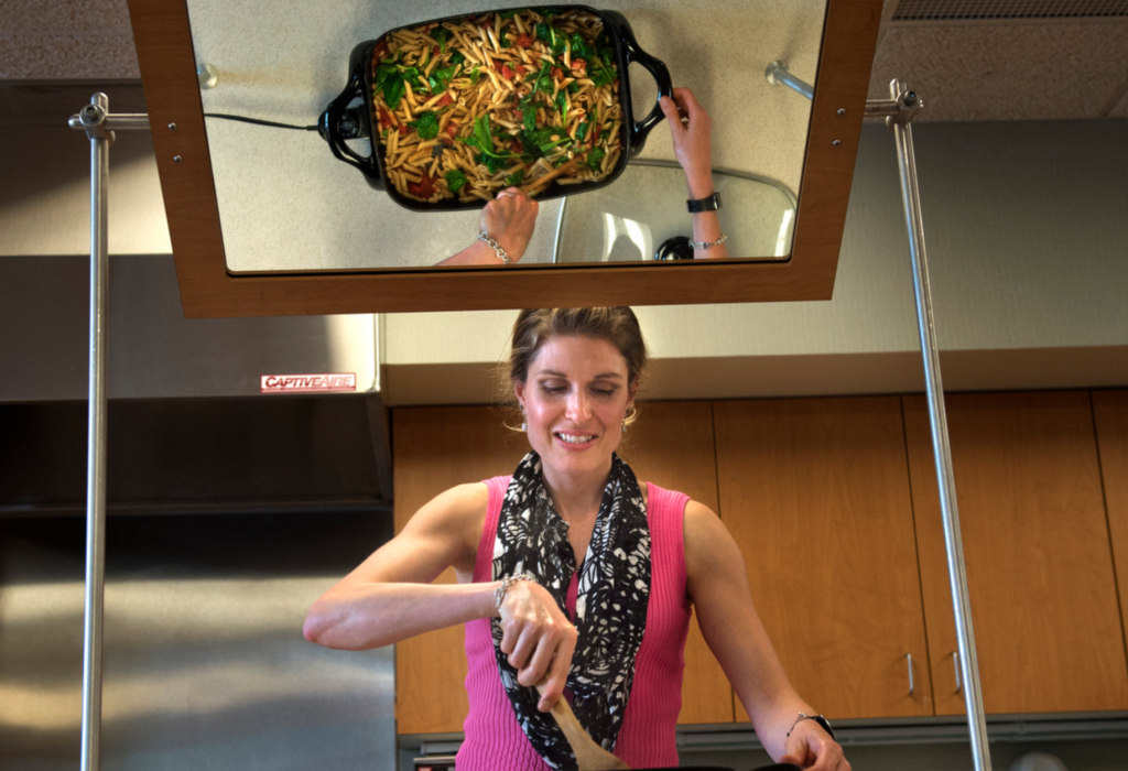 Dietitian Jessica Corwin, a community nutrition educator at Spectrum Health Healthier Communities, prepares a "One Dish Italian Skillet" during her "Farm to Fork Cooking Series" class.