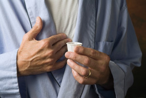 A person holds a proton pump inhibitor in their hand.