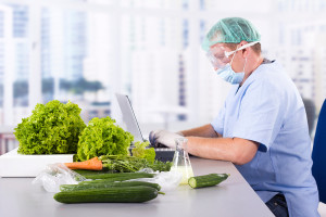 A medical professional analyzes vegetables that may have E. coli.