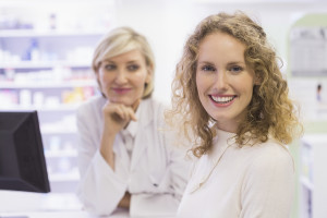 A woman smiles at a drugstore.