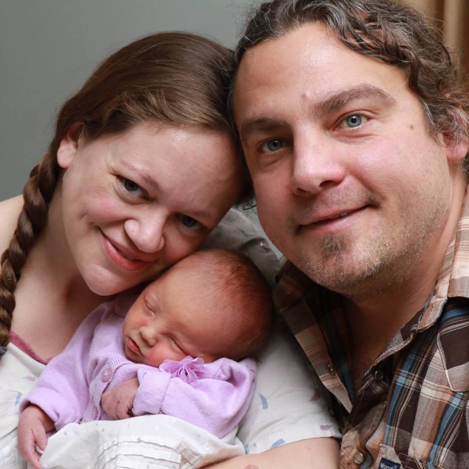 Matt Kerwin, of Rockford, Michigan, poses for a photo with his wife and newborn daughter, Kayla.