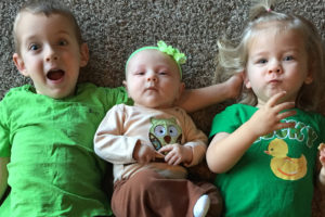 Gage Wolf, 4, Jada Wolf, 5 months, and Lucy Wolf, 2, are shown posing for a photo.